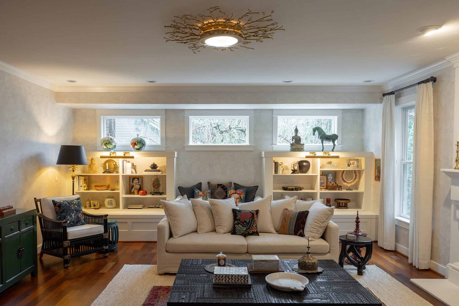 Cozy living room featuring built-in shelves, a white sofa, and decorative accents for stylish comfor.