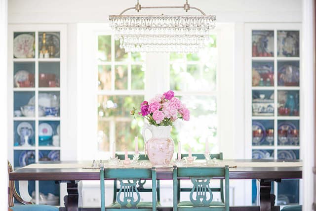 dining table with turquoise chairs and floral design